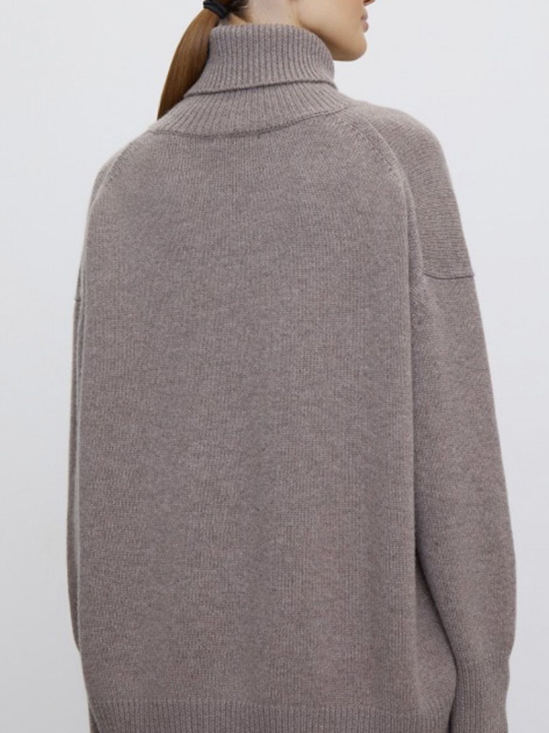 Relaxed turtleneck sweater in Dust Storm acrylic with sculptural sleeves and ribbed cuffs.