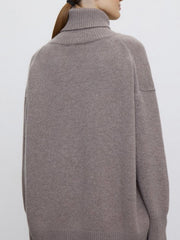 Relaxed turtleneck sweater in Dust Storm acrylic with sculptural sleeves and ribbed cuffs.