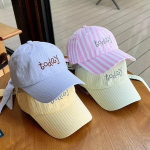 Pastel striped cotton baseball caps in pink, blue, and yellow, each embroidered with "today".