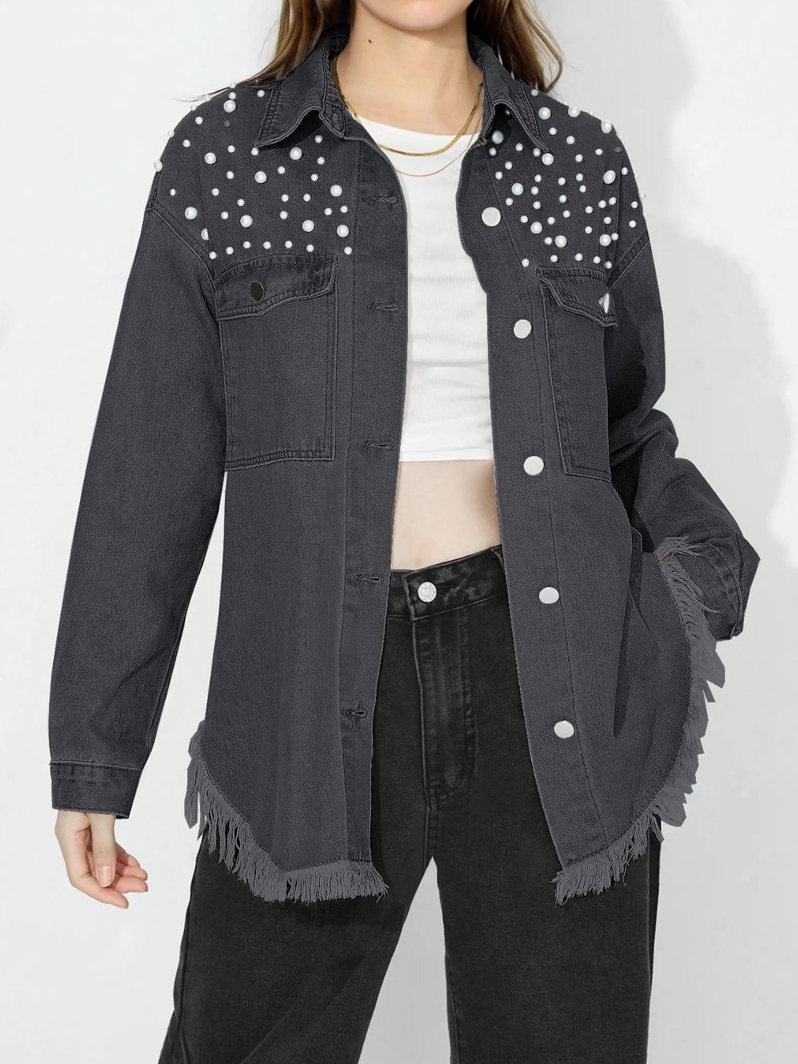 Dark denim shirt with pearl embellishments on shoulders and frayed hem.