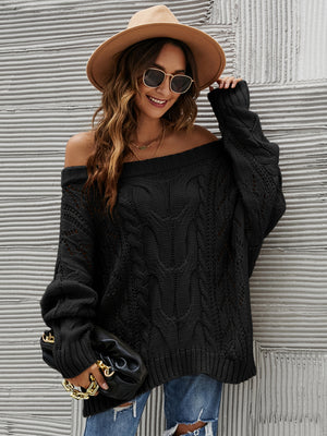 Black cable knit off-shoulder slouch sweater with detailed knit pattern.