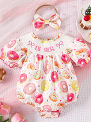 Baby girl's white cotton smocked one-piece with donut print and matching headband.