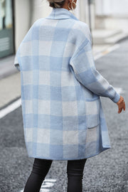 Light blue and white checkerboard knit duster coat with pockets.