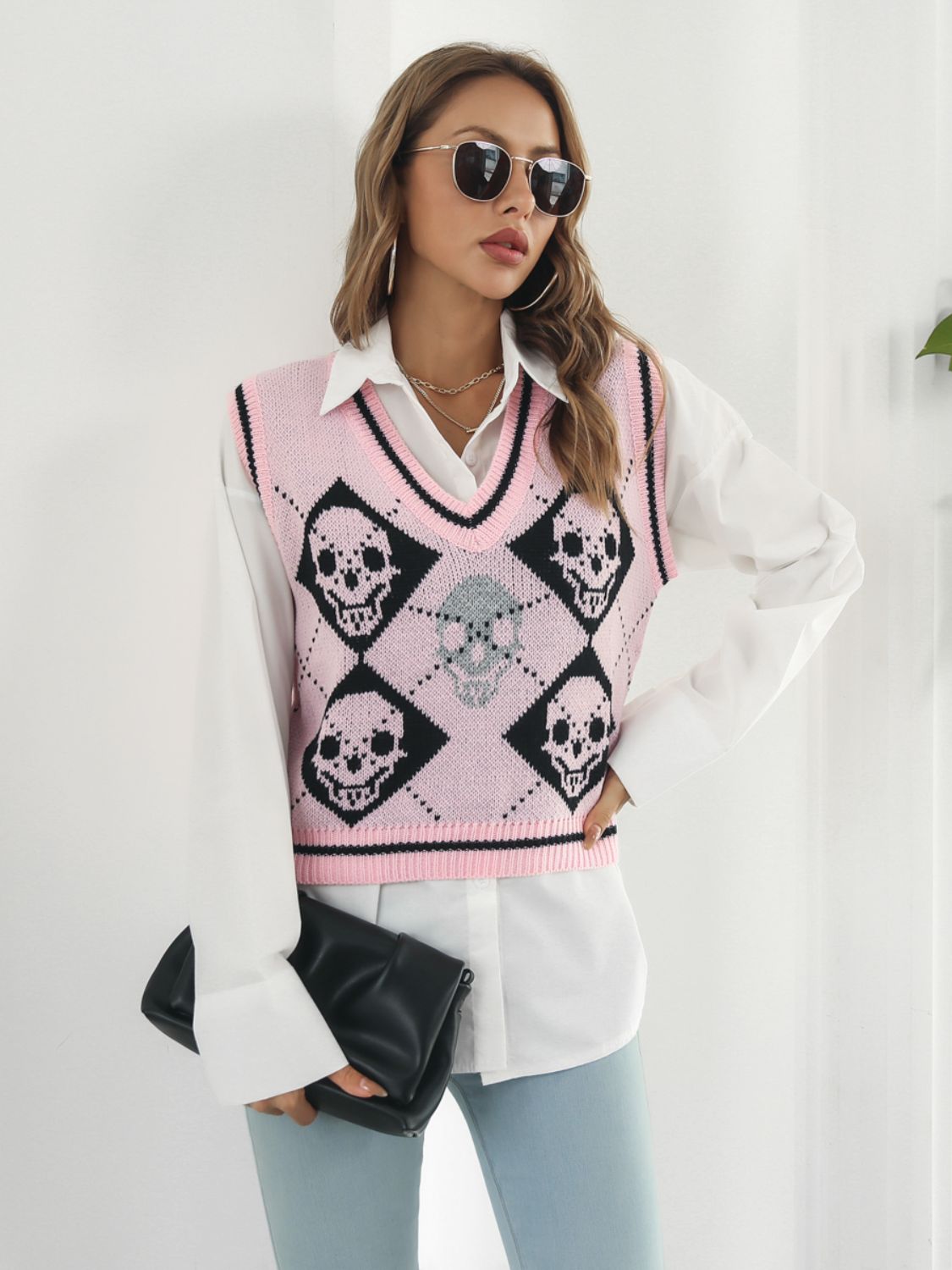 Blush pink argyle knit vest with skull motif and V-neck.