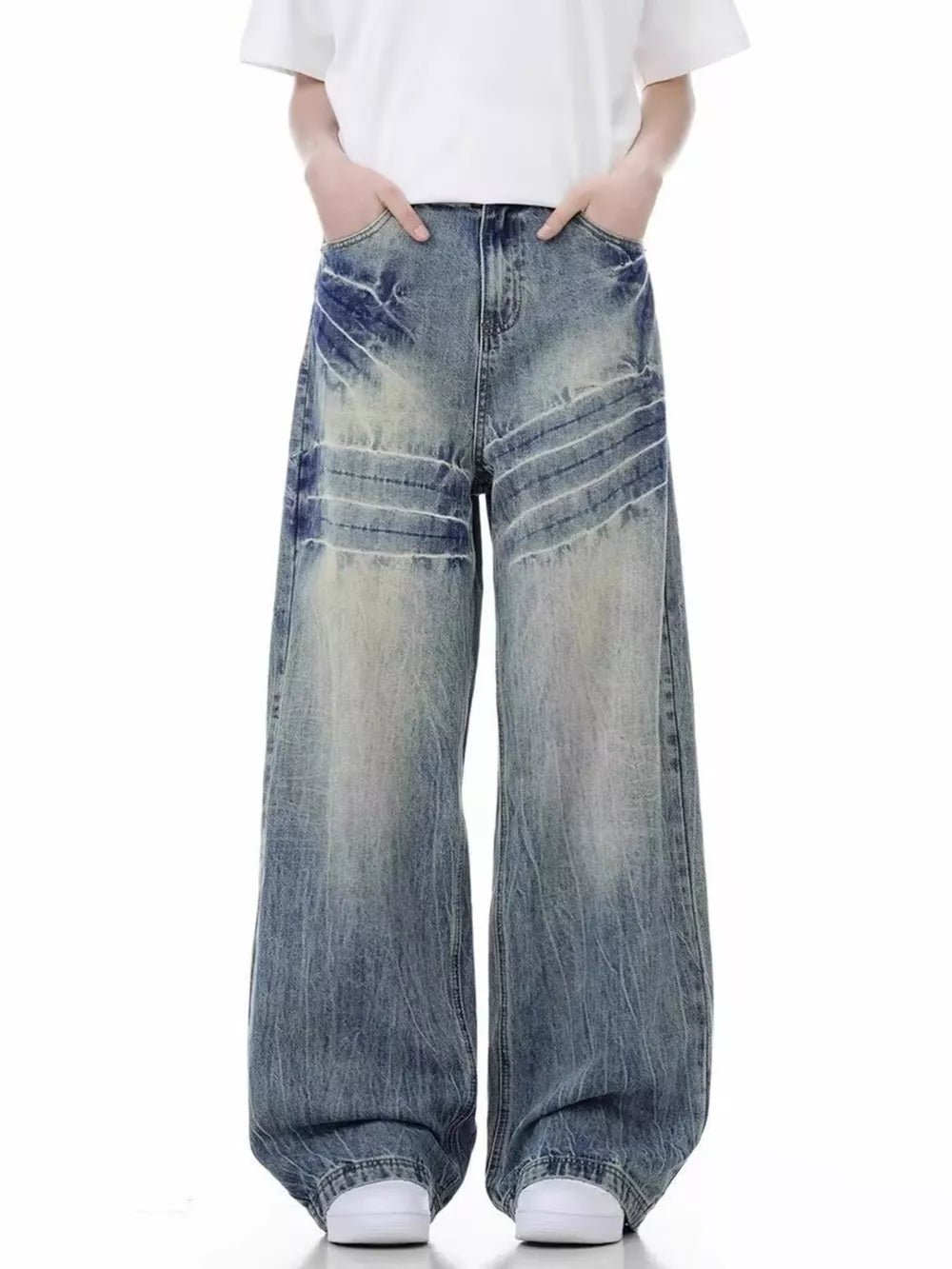 Men's distressed vintage wide-leg jeans in washed blue denim with faded details.