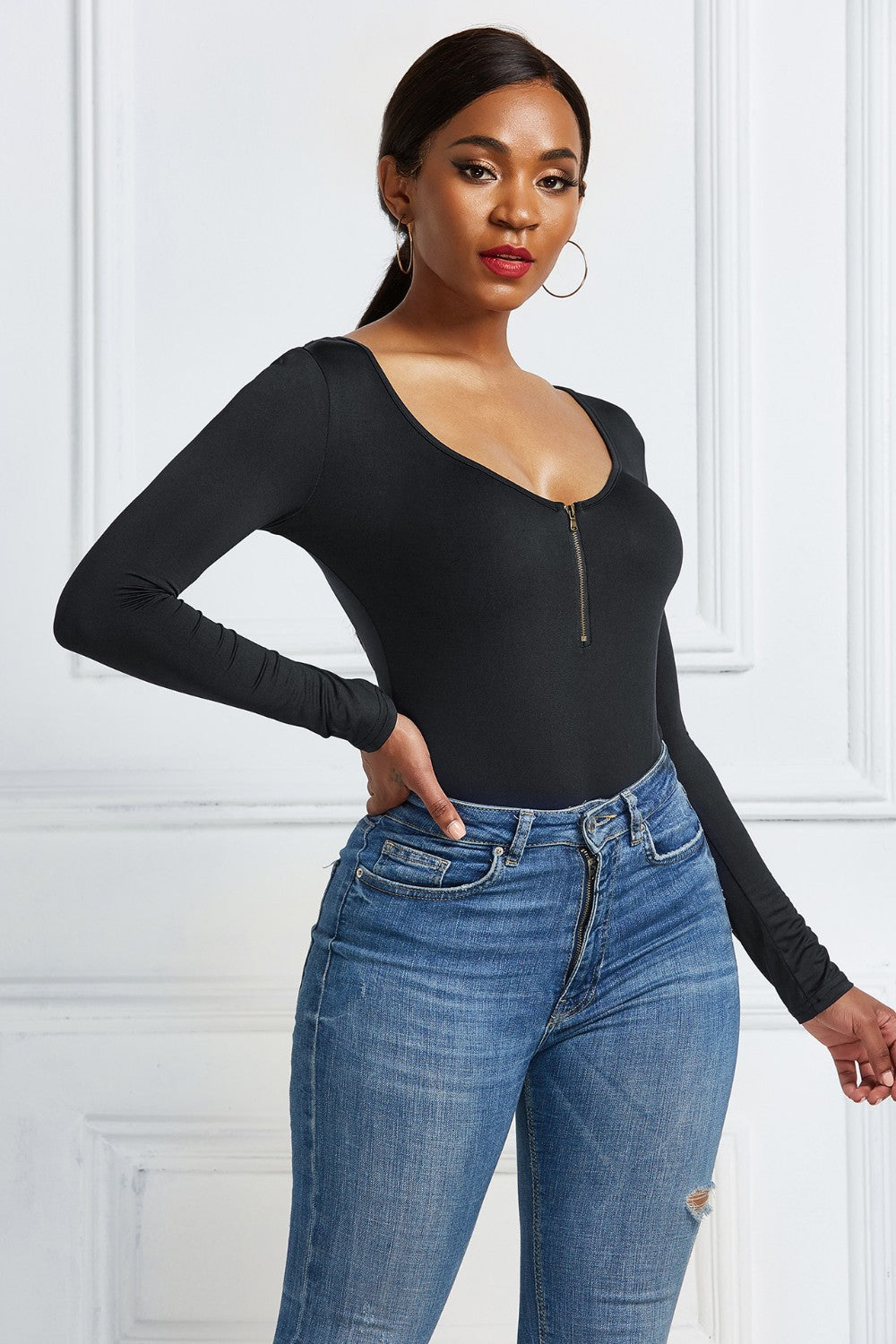 Black long sleeve bodysuit with plunge neckline and zip front detail.