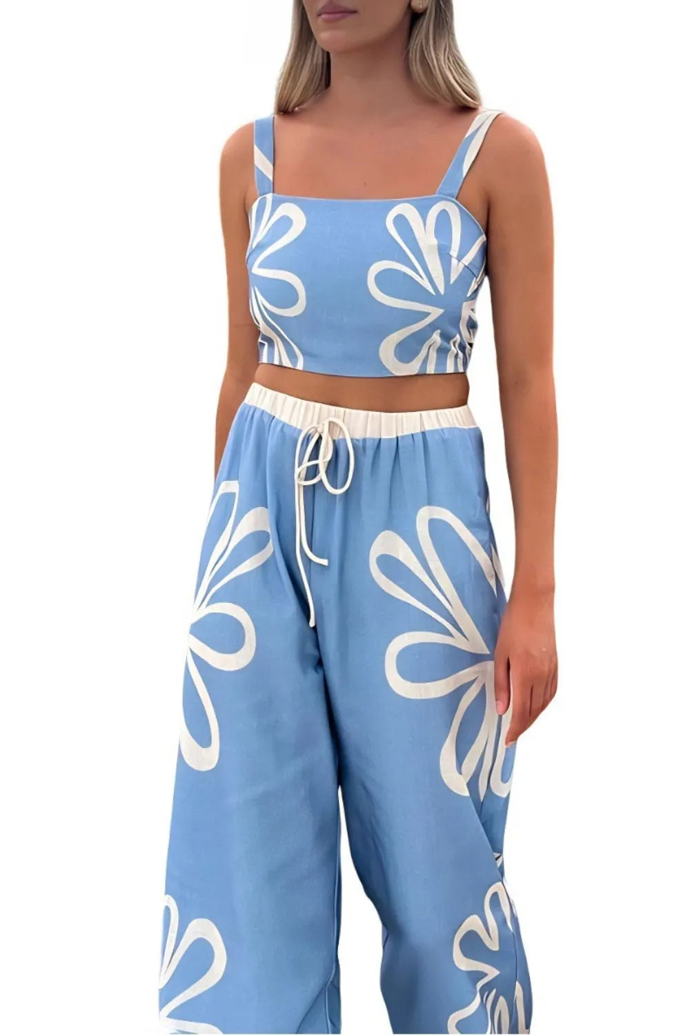 Light blue linen co-ord set with white floral print, crop top, and wide-leg pants.