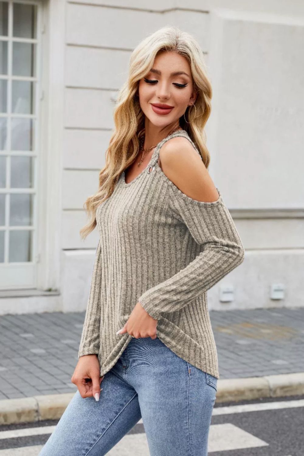 Gray ribbed cold-shoulder top with ring detail and long sleeves.