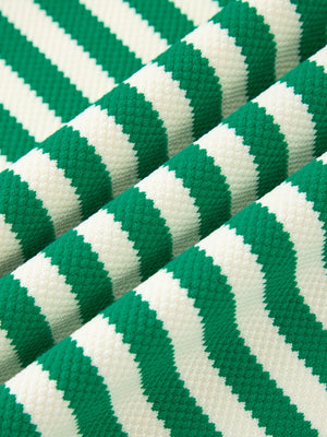 Green and white striped sweater with elastane, showing fabric texture.