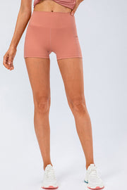 Sculpted performance shorts in coral with side pockets and a high waist.
