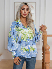 Light blue floral print blouson sleeve button-up shirt with smocked cuffs.