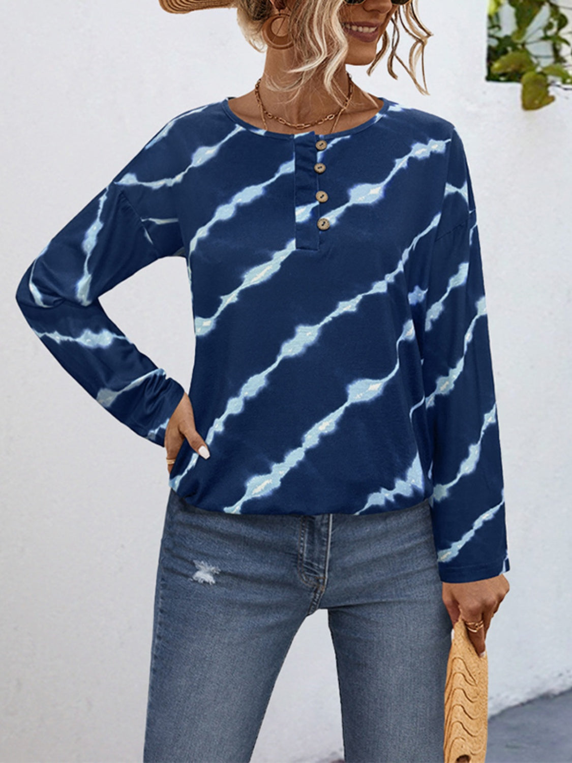 Indigo tie-dye henley top with button neckline and long sleeves