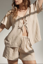 Beige cotton tie-front top and drawstring shorts set with textured fabric.