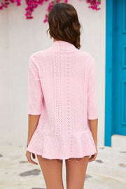 Perforated peplum sleeve cardigan in blush pink with 3/4 sleeves and a ruffled hem.