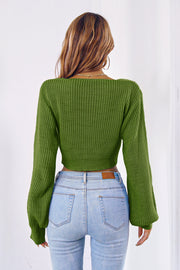 Green acrylic knit crop sweater with balloon sleeves and tie-front detail.