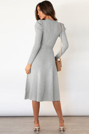 Light gray cable knit midi dress with self-tie belt and long sleeves.