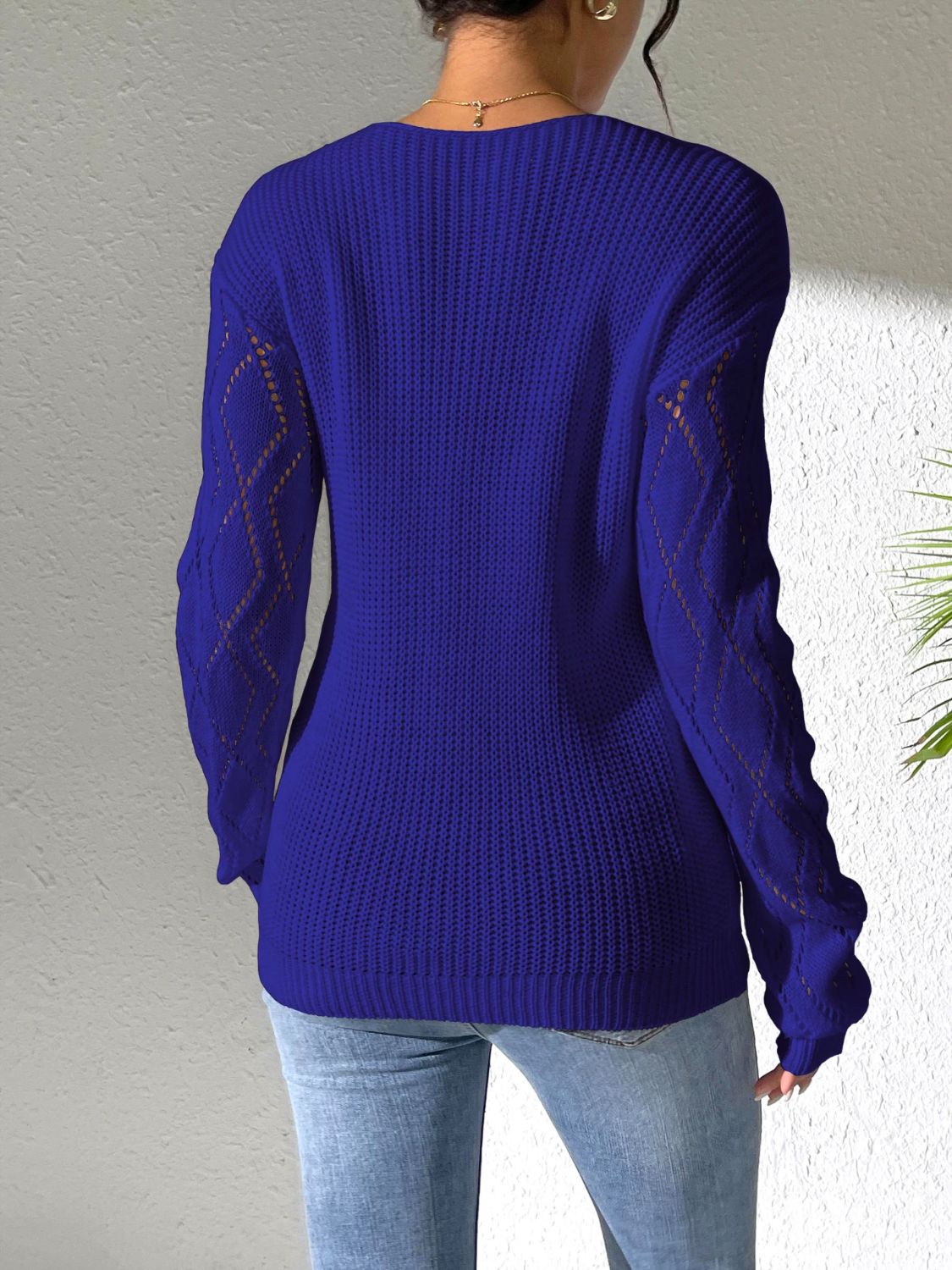 Dark blue acrylic knit sweater with openwork lace detail on sleeves.