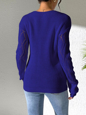 Dark blue acrylic knit sweater with openwork lace detail on sleeves.