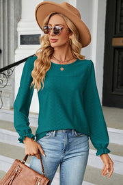 Teal textured puff sleeve blouse with ruffled cuffs and crew neck.