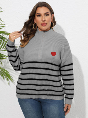 Gray ribbed knit sweater with black stripes, quarter zip, and red heart appliqué.