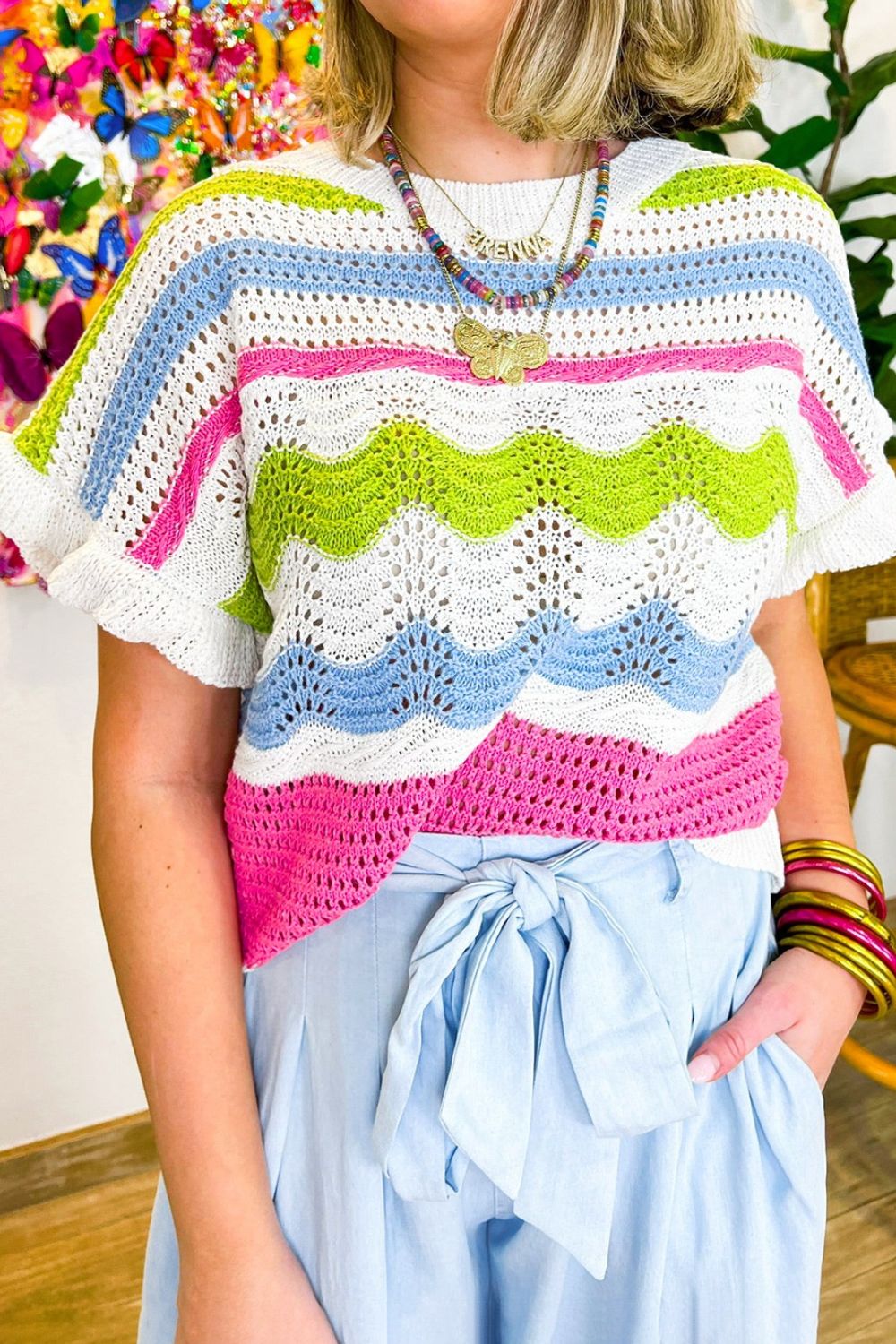 Scalloped crochet tee with ruffle sleeves in stripe pattern and colorblock design.