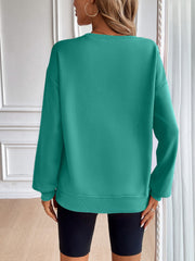 Teal relaxed fit sweatshirt with crewneck and long sleeves, ribbed cuffs and hem.