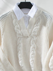 Cream cable knit V-neck sweater with textured details and a white collared shirt underneath.
