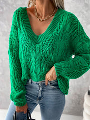 Green cable knit v-neck sweater with relaxed fit and detailed texture.