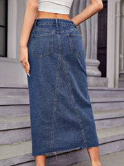 Denim maxi skirt in medium wash cotton with front seam detail and raw hem.