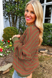 Brown waffle knit top with green stripes and contrast sleeves.