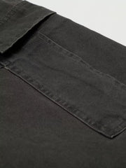 Grey cargo pants with flap pocket detail and visible stitching.