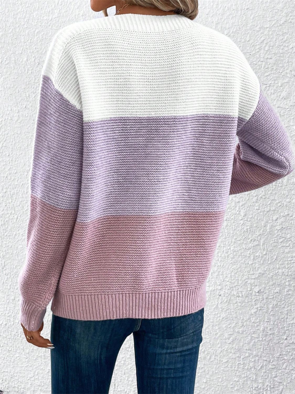 Colorblock boatneck knit sweater with horizontal stripes in white, lavender, and pink.