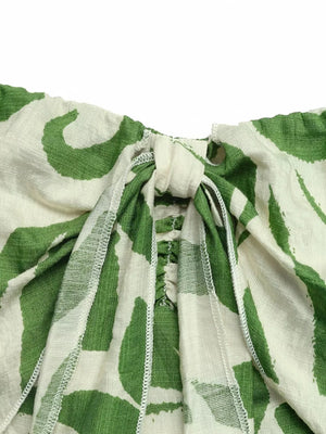 Tropical tie-front strapless maternity jumpsuit with green leaf print and ruched detail.