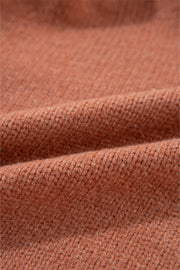 Open-front cropped knit cardigan in burnt coral acrylic with a ribbed texture.