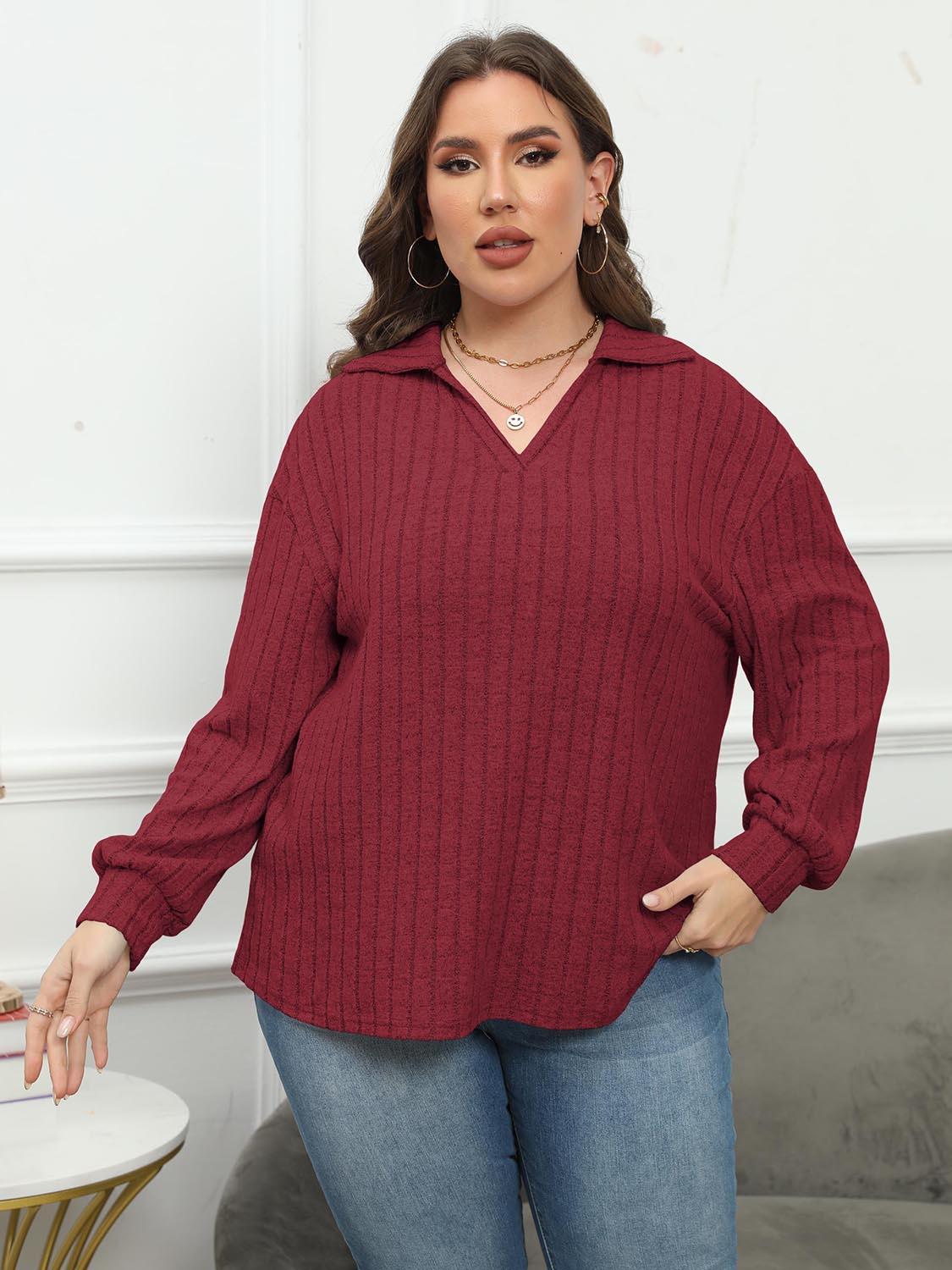 Relaxed ribbed polo top in Brick Red with a V-neck and long sleeves.