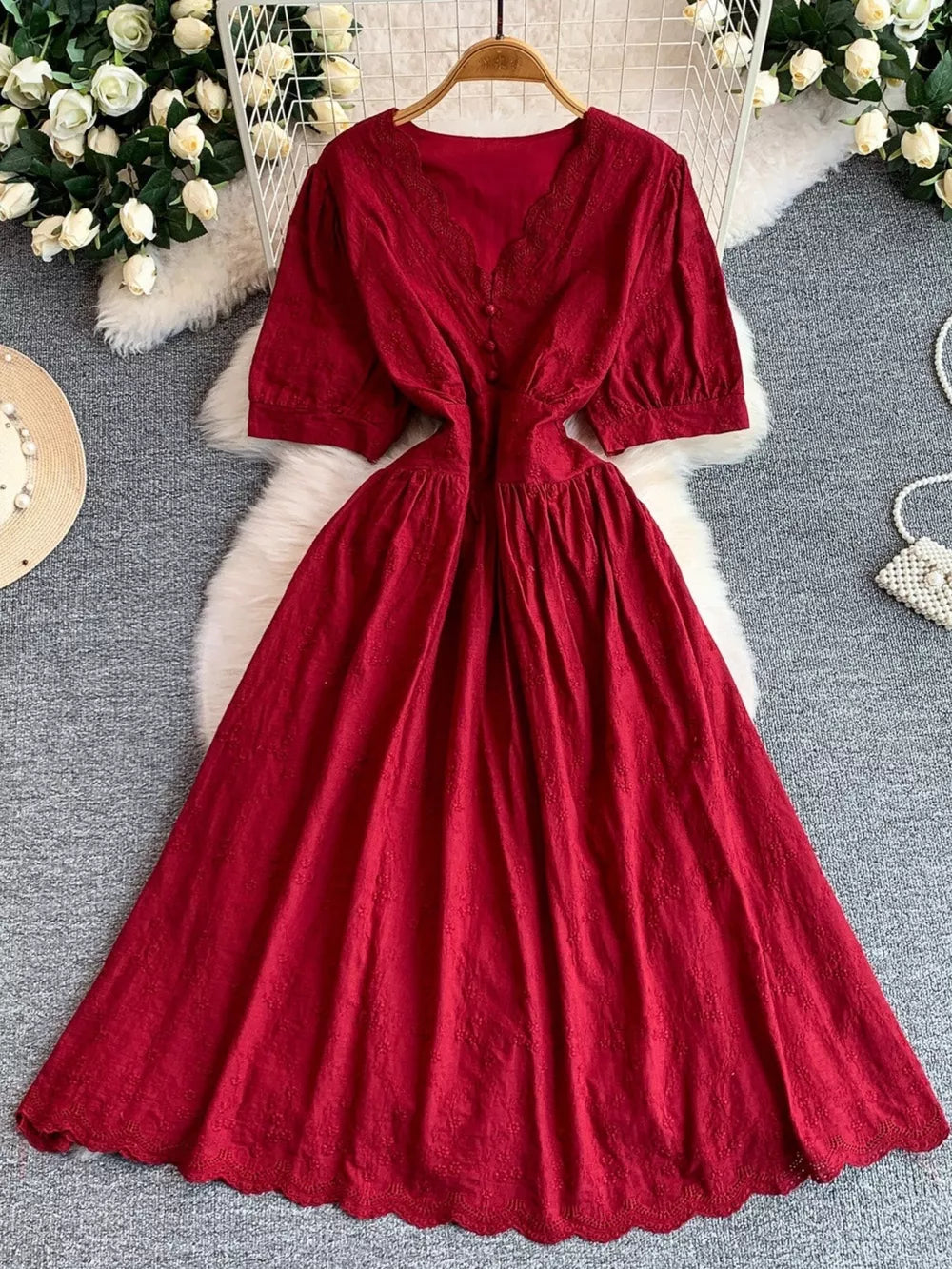 Crimson lace-embellished midi dress with V-neck, puff sleeves, and button detail.