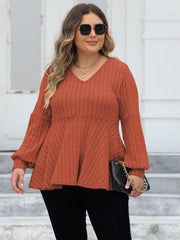 Ribbed peplum blouse in Red Orange with blouson sleeves and V-neck.