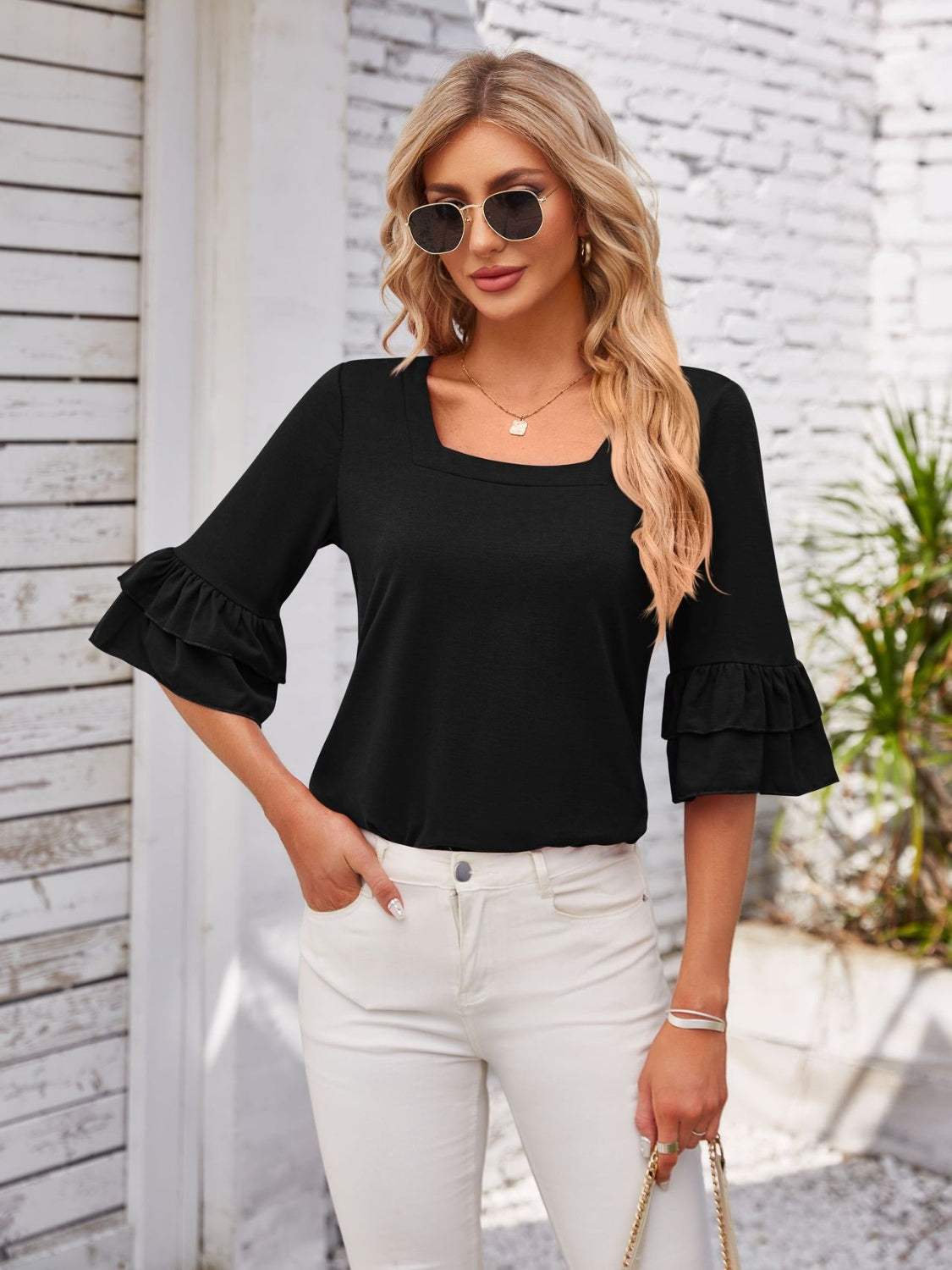 Black blouse with square neckline and ruffled sleeves