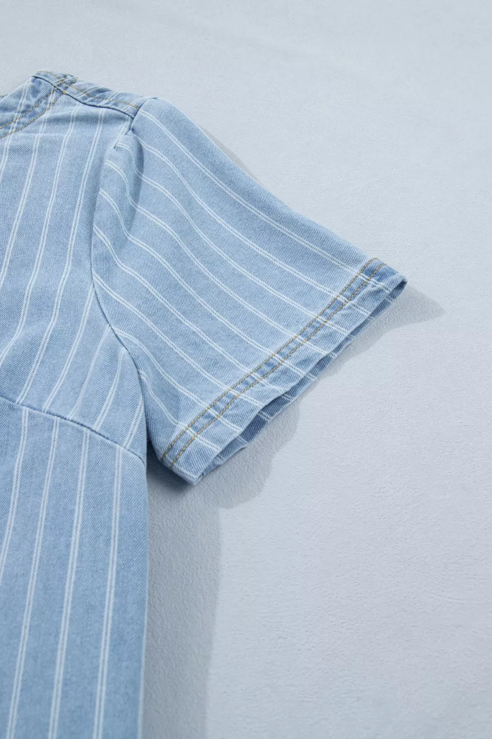 Denim mini dress with vertical white stripes and short sleeves.