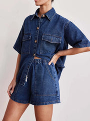 Medium wash denim co-ord set with short sleeve button-up shirt and elastic waist shorts.