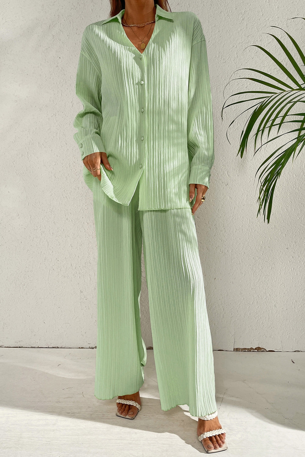 Pastel blue pleated co-ord set with button-down shirt and wide leg trousers