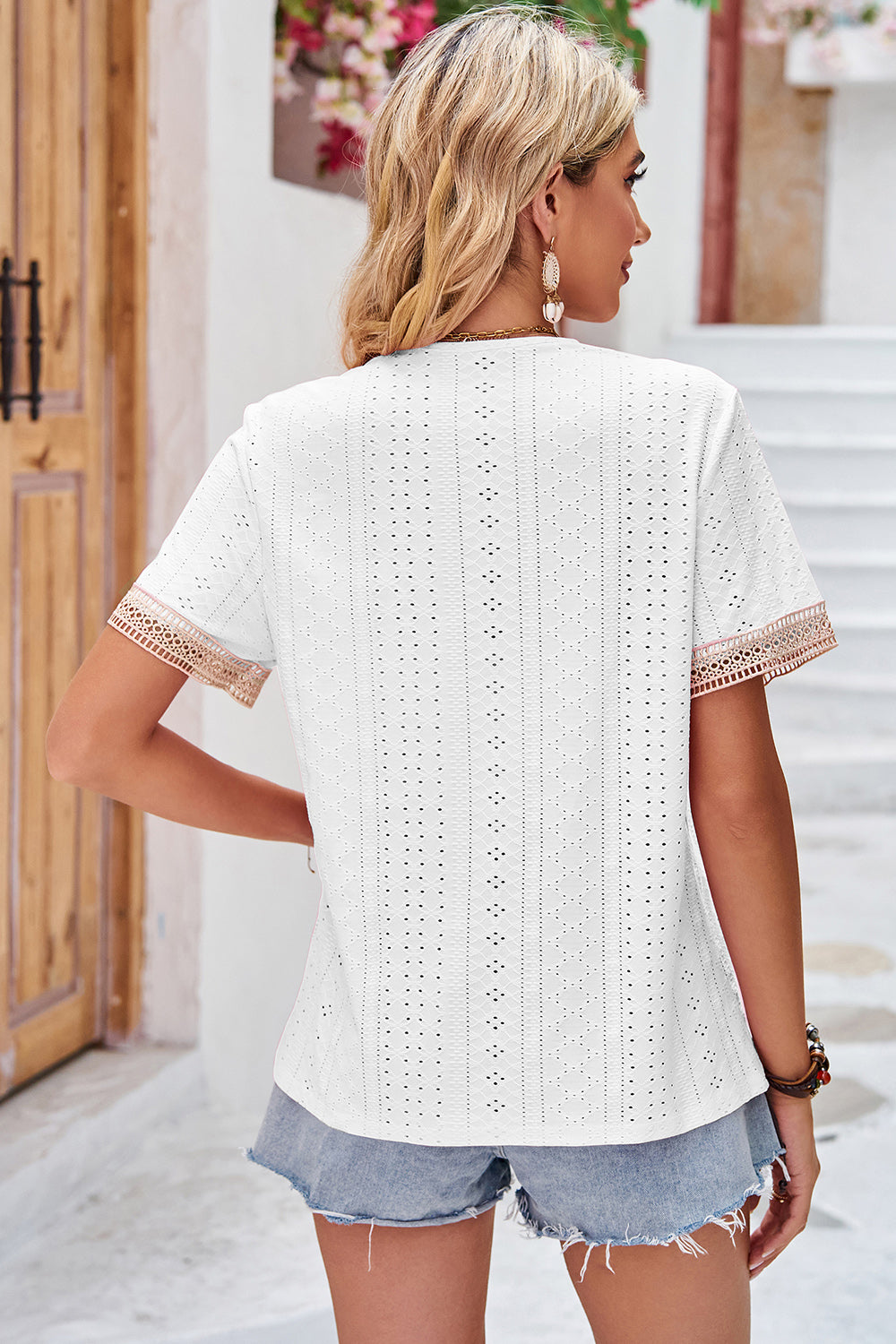 White eyelet blouse with lace trim on sleeves and V-neckline