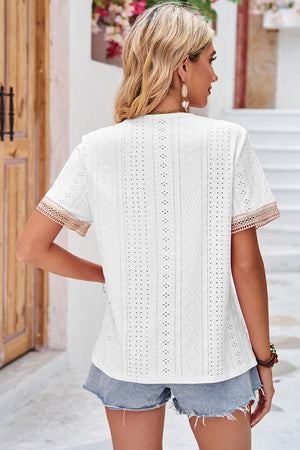 White eyelet blouse with lace trim on sleeves and V-neckline