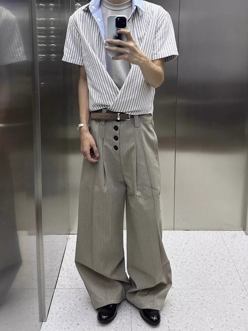 Men's khaki high-waisted wide-leg pants with vertical pinstripes and button closure.