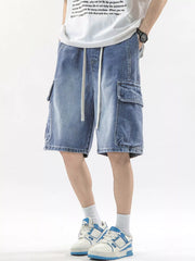 Men's denim cargo shorts in Vintage Blue with drawstring waist and large side pockets.