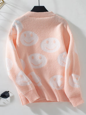 Watermelon pink intarsia knit sweater with allover white smiley faces.