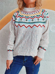 Fair Isle cable knit turtleneck sweater in beige with multicolor pattern and cable sleeves.