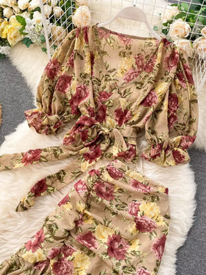 Chic floral crop set with tie waist and puff sleeves in tan with pink and yellow flowers.