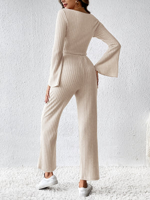 Cream ribbed knit co-ord set with bell sleeves and wide-leg pants.