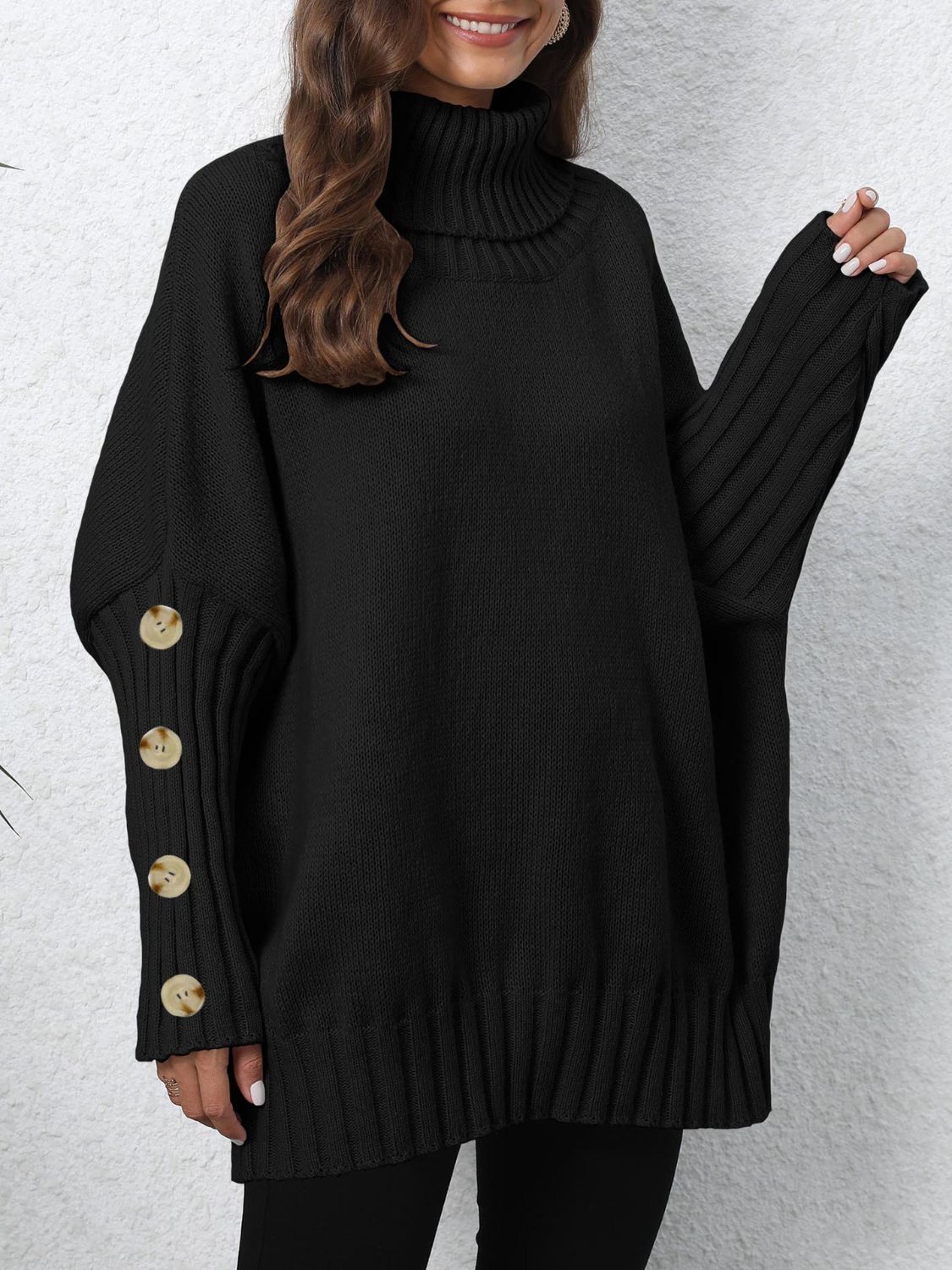 Black turtleneck sweater with button cuff detail and ribbed sleeves.